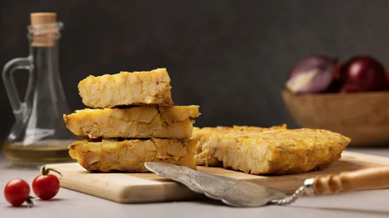 Tempeh na dřevěné desce s olivovým olejem a cibulí