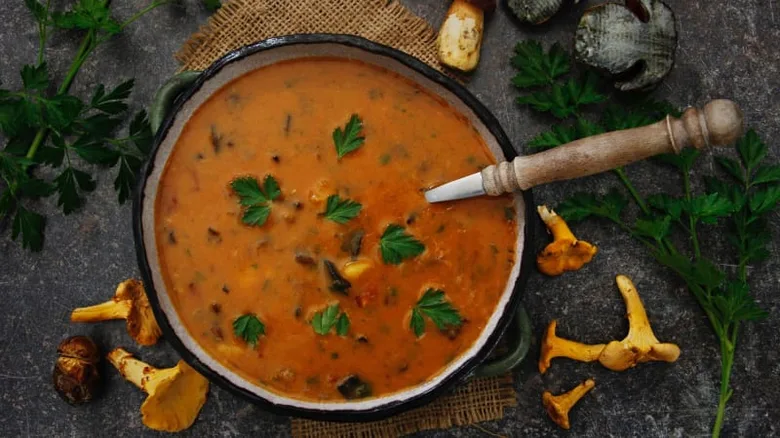 Hot homemade potato soup with herbs and wild mushrooms.