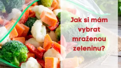 Mražená smíšená zelenina v plastovém saku na dřevěné desce.