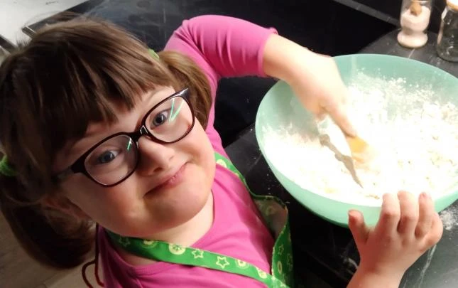 Girl with down syndrome baking