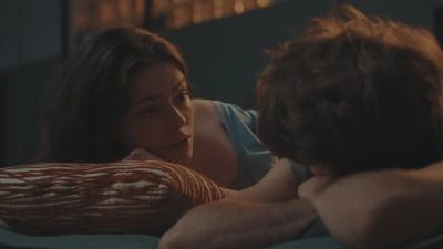 Parents talking to child in bed