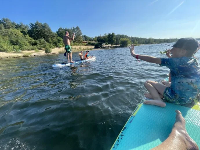Family paddleboarding on lake