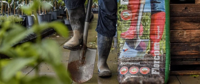Zahrádkář s lopatou vedle balení kompostu pro začátečníky