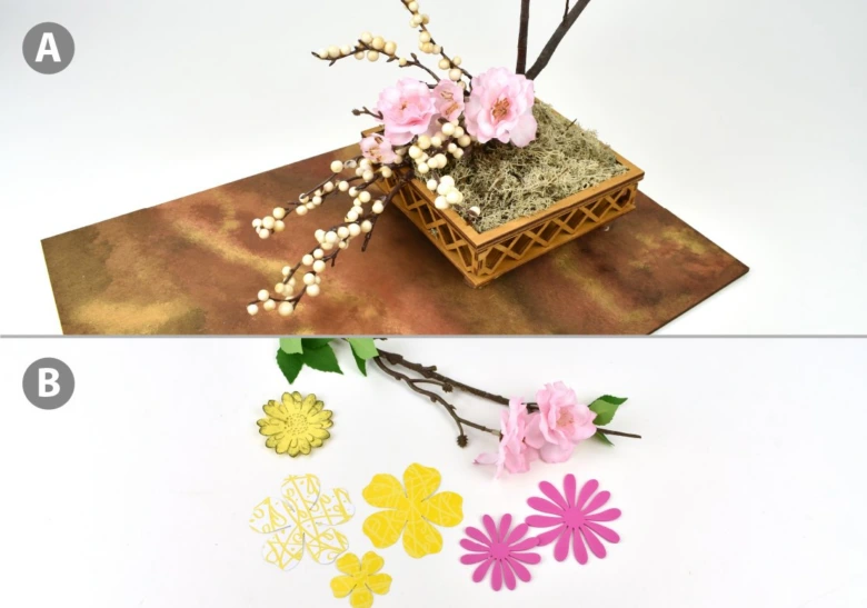 Japonská květinová aranžmá ikebana s růžovými květy a větvemi na hnědém podkladu.