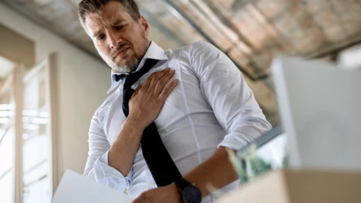 Man clutching chest in pain