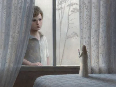Boy looking at angel figure